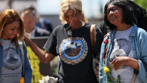 Reuters Family members of George Floyd comfort each other during a memorial