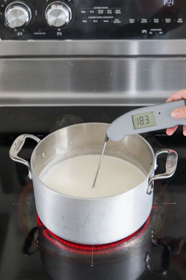 Taking the temperature of the ice cream base, thermometer reads 183 degrees F.