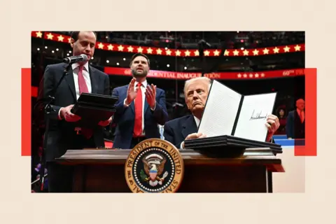 AFP via Getty Images US President Donald Trump holds an executive order announcing the US withdrawal from the Paris Agreement