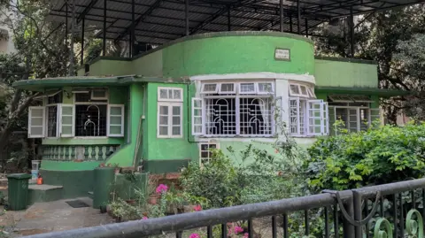 Art Deco Mumbai Trust Arthur Lodge in Mumbai's Borivali suburb, which is a pistachio-coloured building with a circular front constructed in the Art Deco style.